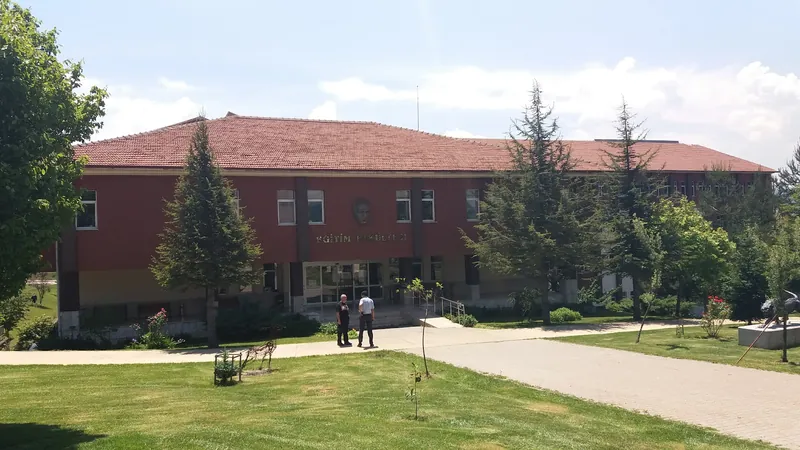 Eğitim Fakültesi binası, kırmızı tuğla cephe ve önündeki çimenlik alan